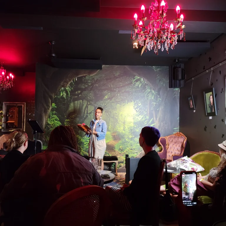 Woman in denim jacket reading her poem