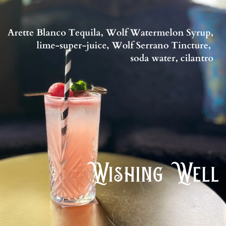 Wishing Well Cocktail in a collins glass. Drink ingredients listed