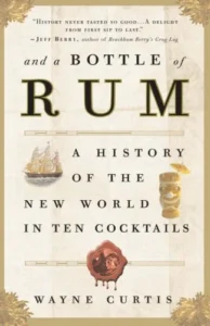 the cover of the book And a Bottle of Rum by Wayne Curtis - A history of the new world in ten cocktails